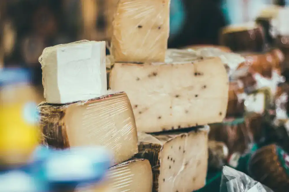 A variety of hard cheeses stacked together